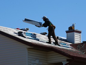 Roofers will work in Saddleridge on Monday, May 10, 2021. Repairs to damaged homes in Calgary's northeastern neighborhoods continued after last year's massive hail storm.