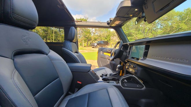 The 2021 Ford Bronco has an integrated roof roll bar, removable plastic/cloth roof and a washable interior (with vinyl option).
