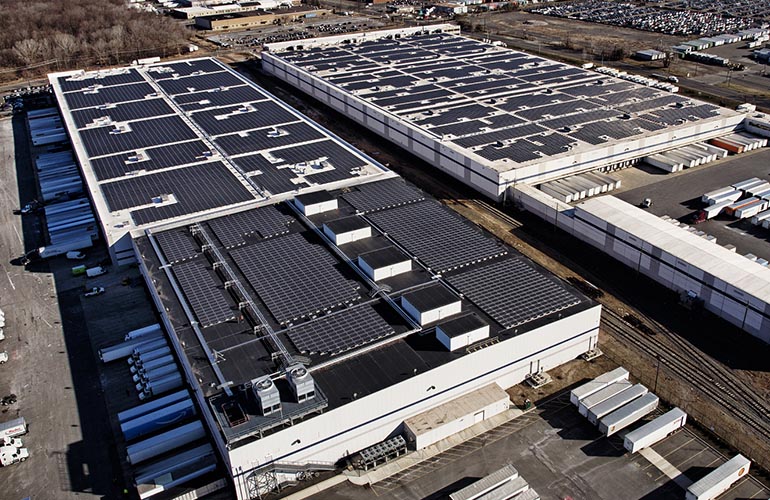 amazon-EWR6-nj-p2photography Pictured is a rooftop solar system installed at Amazon’s fulfillment warehouse in Avenel, New Jersey. The company met a goal to install solar at 50 of its distribution centers worldwide. With on-site arrays alone, Amazon has approximately 11,700 modules at its warehouses. P2 Photography