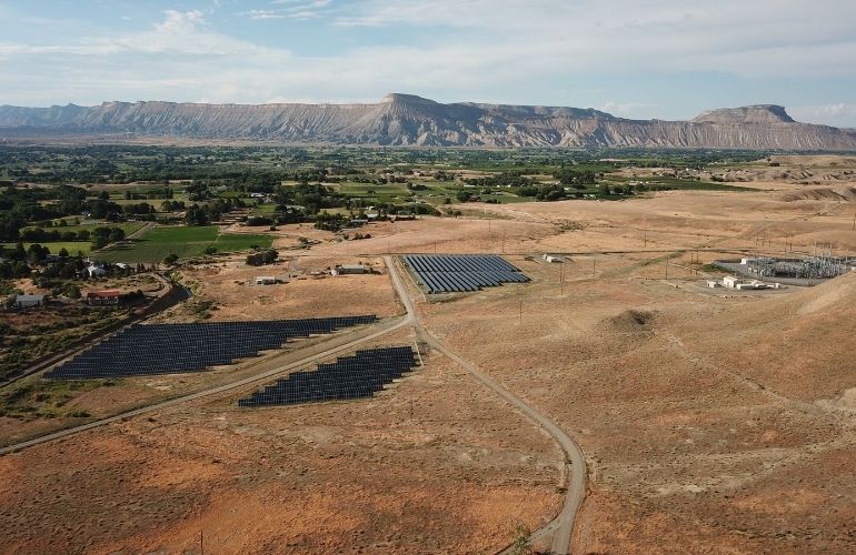 pivot energy 2 Pivot Energy's Mesa 2 Community Solar Garden in Colorado, with electricity transmission infrastructure visible in the background.